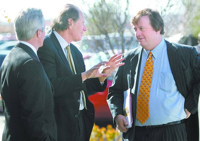 Cathleen Allison/Nevada Appeal From left, Jim Coulter and David Bonderman, executives of Hamlet Holdings, talk with Harrah&#039;s chief executive Gary Loveman outside the Gaming Control Board on Wednesday. Hamlet Holdings received preliminary approval from state regulators to go ahead with the private equity purchase of Harrah&#039;s.