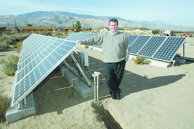BRAD HORN/Nevada Appeal Richard Gunkel stands next to his residential solar panel system which is a 6 Kilowatt PV array at one of his Carson City properties Wednesday. Gunkel is a consultant for alternative forms of energy.