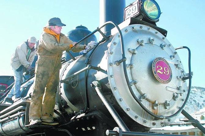 Amy Lisenbe/Nevada Appeal V&amp;T Railroad employees Dennis Nelson, front, and Norman Nicht clean the engine jacket of V&amp;T&#039;s Engine 29 at the V&amp;T yard in Virginia City on Tuesday afternoon. The railway is in the process of readying the engine for use this spring.