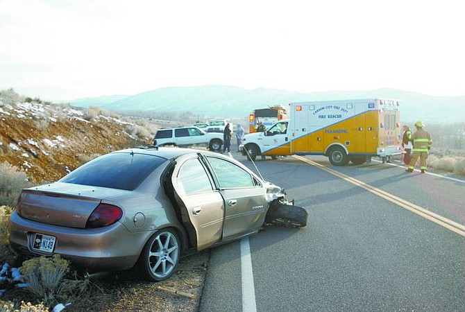 BRAD HORN/Nevada Appeal One of the cars involved in an accident on Deer Run Road sits disabled on the side of the road Wednesday. The occupants of the Dodge Neon claim they were being chased by a white sedan that left the scene of the accident.
