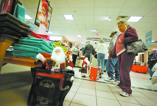 BRAD HORN/Nevada Appeal JC Penny customers take advantage of some of the post-Christmas specials on Wednesday morning. These Santa&#039;s were on sale for 70 percent off.