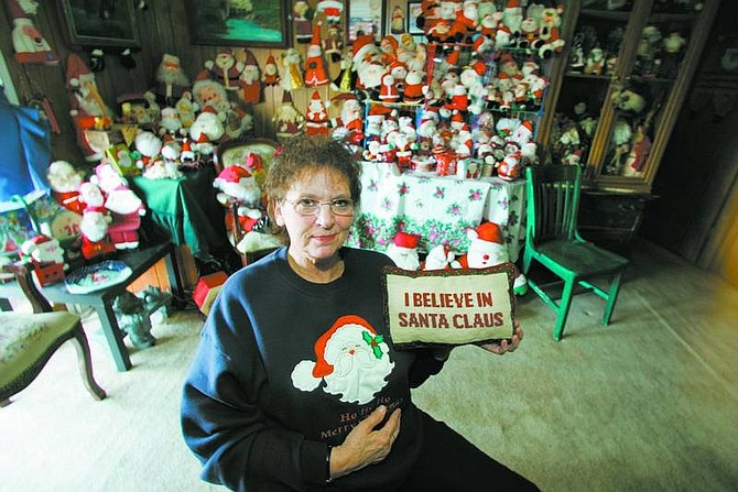 BRAD HORN/Nevada Appeal Pam Olvera has collected more than 2,300 Santas ranging from the icon in traditional poses to the North Pole resident surfing.
