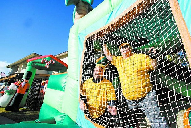 BRAD HORN/Nevada Appeal Jeff Burian, left, and Larry Kemp pose in one of Fun Jumper&#039;s bounce castles on Thursday.
