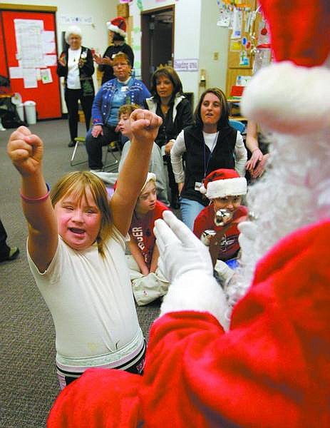 Cathleen Allison/Nevada Appeal Brianna Stark, 9, sings &quot;Rudolph the Red-Nosed Reindeer&quot; during the eighth annual Carson City AT&amp;T Pioneers Christmas party at Seeliger Elementary School on Friday.