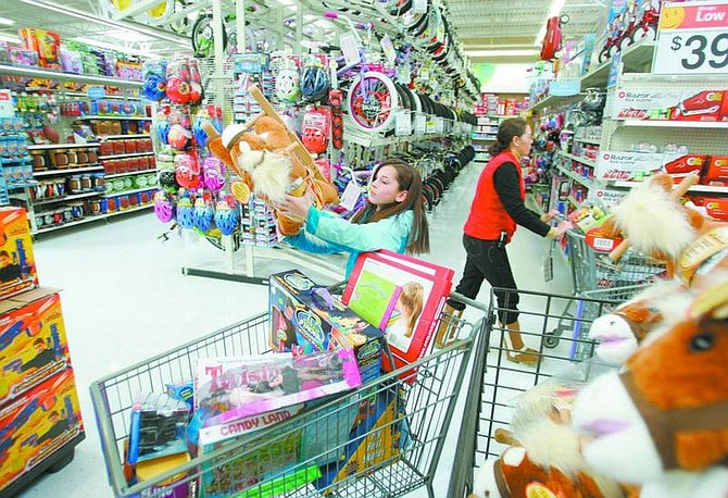 BRAD HORN/Nevada Appeal Leanna Temple, 10, shops for the Toys for Tots program at Wal-Mart with money she raised from selling her homemade peanut brittle.
