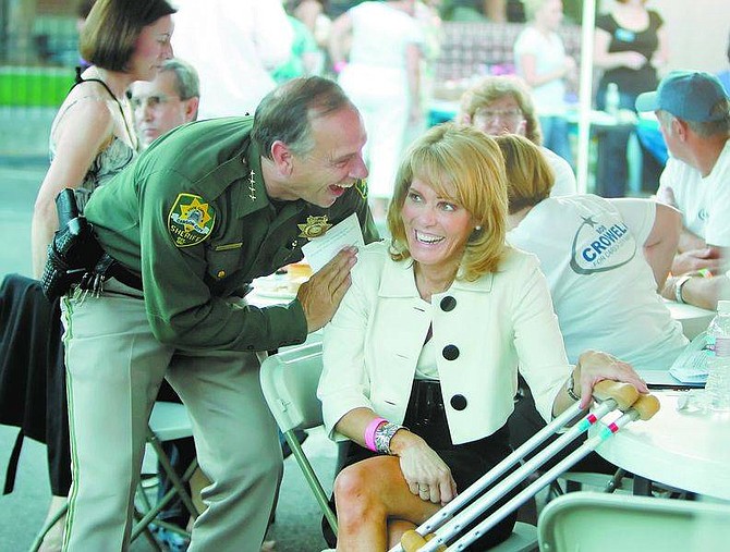 BRAD HORN/Nevada AppealCarson City Sheriff Ken Furlong and Nevada First Lady Dawn Gibbons share a laugh before the beginning of the auction at &quot;Lead Them To Learn,&quot; a benefit hosted by the Carson City Active 20-30 at the Brewery Arts Center on Friday.