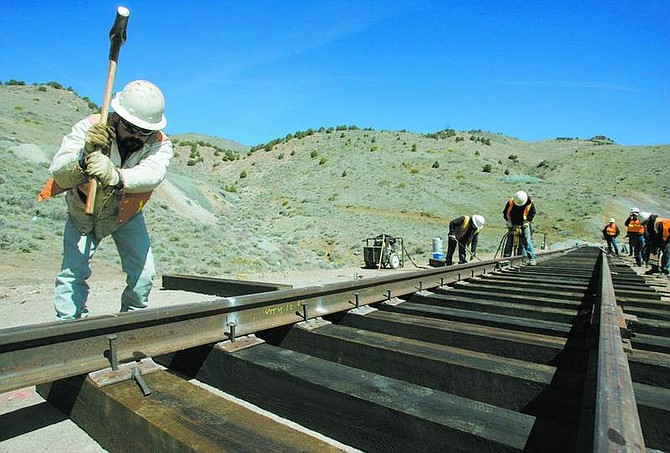 BRAD HORN/Nevada Appeal Juan Velasco hammers a spike into place Friday at the Phase 2 area of the Virginia &amp; Truckee Railway.