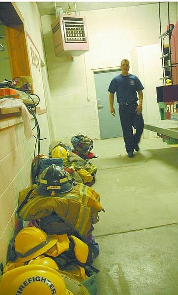 Nevada Appeal File Photo In this photo from 2006, volunteer firefighter Danial St. Clair walks past fire gear in the Silver Springs Volunteer Fire Station. A new station should be ready to be moved into by November.