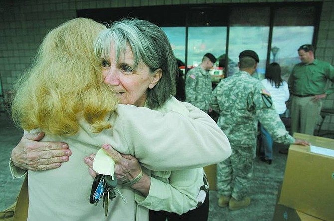 BRAD HORN/Nevada Appeal Kathy Brockway hugs Jo Sprinkle at the Starbucks store in north Carson City on Wednesday. Starbucks locations in Northern Nevada are sending 300 pounds of coffee to soldiers stationed in Iraq. Brockway&#039;s son Aaron is stationed in Iraq.