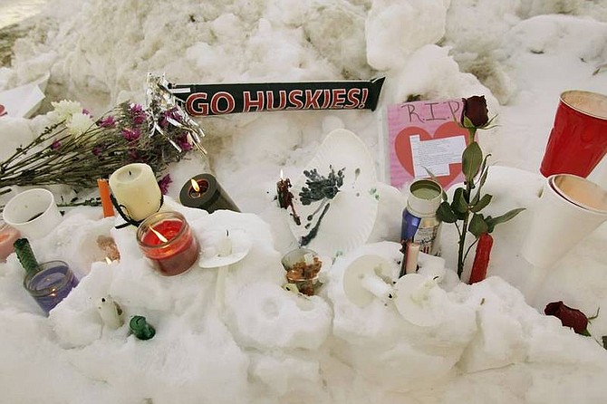 AP Photo/Nam Y. HuhFlowers, candles, and small notes sit in the snow Friday on the campus of Northern Illinois University near Cole Hall, the scene where a lone gunman shot and killed six Thursday on the NIU in DeKalb, Ill.