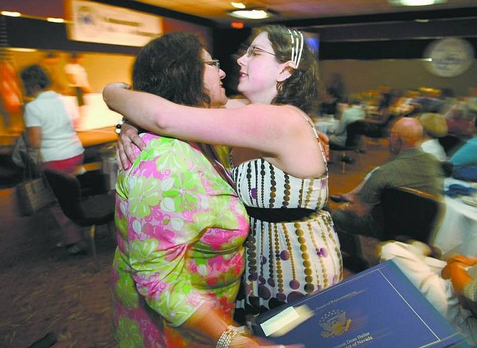Cathleen Allison/Nevada AppealApril Hyatt, 19, congratulates her mother, Rose Marie Painter, after Painter was named Volunteer of the Year during Thursday&#039;s Community Awards Banquet at the Carson Nugget.