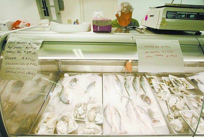 BRAD HORN/Nevada AppealT.J. Chaikwang displays fish at Bangkok Tokyo Market on Winnie Lane on Thursday.
