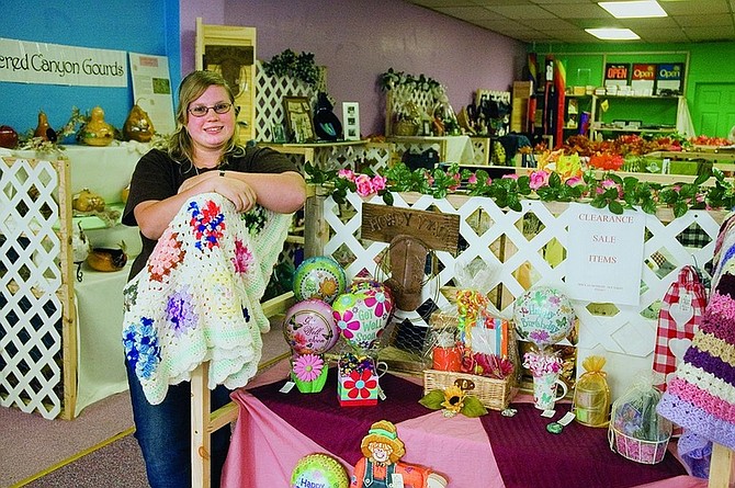 Christy Lattin/Nevada Appeal News Service Jenna Richardson, manager of Fallon Crafters Corral, stands near one of the 22 craft booths located in the store.