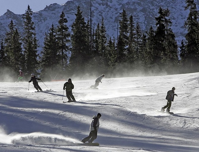 ** ADVANCE FOR WEEKEND EDITIONS OCT. 18-19 ** In this photo provided by Colorado Ski Country USA, skiers ski a run during opening day at Arapahoe Basin Ski Area in Silverthorne, Colo., Wednesday, Oct. 15, 2008. Arapahoe Basin is the first ski area in North America to open for the 2008-2009 ski season. Early sales and reservation numbers for some destination ski resorts suggest the nation&#039;s financial crisis could put a crimp on the $6 billion ski industry. But industry leaders say past downturns _ such as the 1970s fuel crisis and the post-2001 terrorist attacks _ show that snow and proximity to urban areas matter. (AP Photo/Colorado Ski Country USA, Jack Dempsey)**NO SALES**