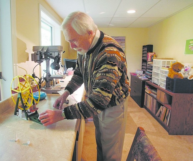 Hank Atkins demonstrates a game he designed and built in his Bloomfield, Conn., workshop. He has sold dozens of his games to large companies. Illustrates GAMEMAKER (category f) by Janice Podsada (c) 2008, Hartford Courant. Moved Friday, Oct. 17, 2008. (MUST CREDIT: Hartford Courant photo by Michael McAndrews.)