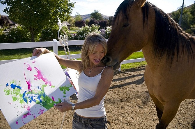 Cholla the painting horse nuzzles his owner Renee Chambers as she holds his latest painting at her ranch in Reno, Nev., Wednesday, Oct. 1, 2008. Cholla&#039;s paintings are set to be exhibited in Italy from Oct. 18- Nov 2. (AP Photo/Scott Sady)