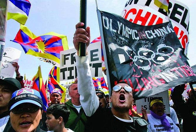 Tibetans and supporters yell at a rally in protest of China&#039;s Olympic torch at City Hall in San Francisco, April 8, 2008. Activists opposing China&#039;s human rights policies and a recent crackdown on Tibet have been protesting along the torch&#039;s 85,000-mile route since the start of the flame&#039;s odyssey from Ancient Olympia in Greece to Beijing, host of the 2008 Summer Olympics.  (AP Photo/Jeff Chiu)