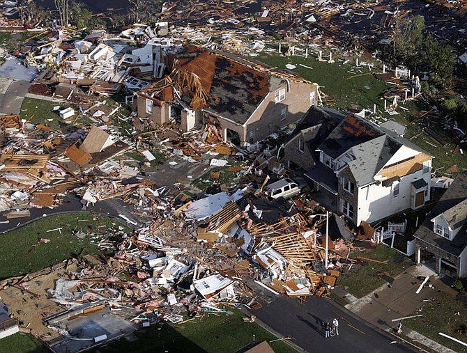 AP Photo/Steve HelberResidents look over damage caused by tornadoes in Suffolk, Va., Tuesday, April 29, 2008. Three tornadoes smashed houses, tossed cars and injured than 200 residents Monday.