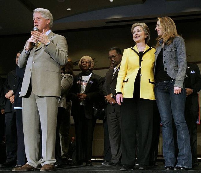 Elise Amendola/Associated Press Former President Bill Clinton introduces his wife, Democratic presidential hopeful Sen. Hillary Rodham Clinton, D-N.Y., while she stands with their daughter, Chelsea, at a rally in Charleston, S.C. Friday.