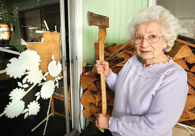 Geraldine &quot;Gerry&quot; Palmer, a week shy of 90, at her Durango Colo., home Monday Feb. 11, 2008, holds the ax that she used earlier in the week to break the glass of her sliding door. On Saturday, she went onto her snow-covered patio, but the door locked behind her, forcing her to use the ax to escape the cold and snow.(AP Photo/The Durango Herald,Jerry McBride)