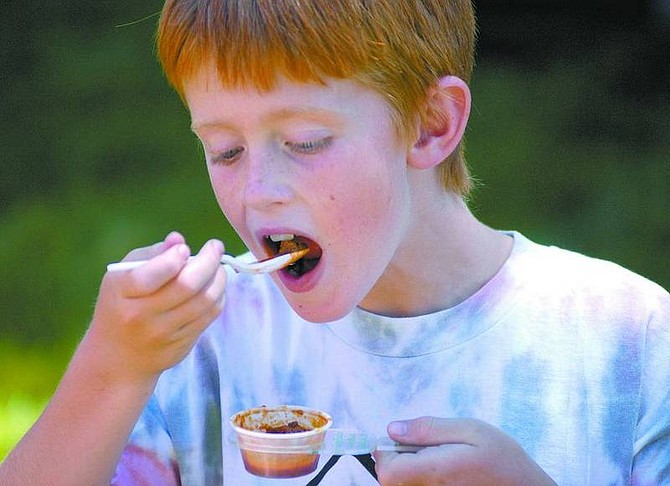 Kevin Clifford/Nevada Appeal File PhotoCaleb Ball, 9, tastes a sample of chili during the Carson City Regional International Chili Society Competition at Glen Eagles last year.