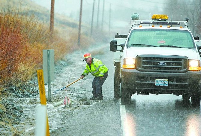 BRAD HORN/Nevada AppealA Nevada Department of Transportation worker clears a storm drain in Kings Canyon Friday.