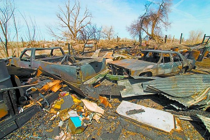 Kim Lamb/Nevada Appeal News Service Three vehicles and a row of out-buildings were lost in a fire Sunday north of Fallon. Homeowner Frank Erb, who was burning leaves at the time, suffered second- and third-degree burns and is in critical condition.
