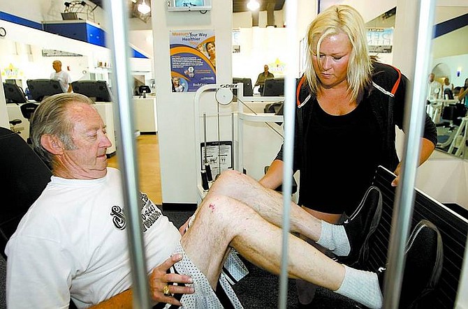 PHOTOSBYShannon Litz/Appeal News Service Dan Smudski, 64, of Johnson Lane works on the leg press machine at Define Fitness with trainer Jill Fujii on Monday. &quot;With somebody beside you, you can&#039;t cheat,&quot; Smudski said. TOP:Fujii explains the different stretches to Mudite Bruns of Minden at Define Fitness.