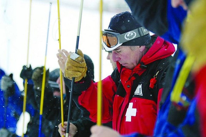 Jen Schmidt/Nevada Appeal nEws Service Diamond Peak ski patrollers push avalanche probes into the snow during an search and rescue drill Friday afternoon at Sheeps Flat. The technique is called a probe line, which advances a step at a time, systematically probing the snow with special poles to pinpoint the exact location of an avalanche victim.