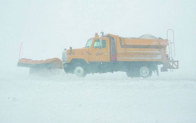 BRAD HORN/Nevada Appeal A Nevada Department of Transportation snowplow moves snow in Washoe Valley on Thursday. Winds between 10-15 mph are expected to continue through Sunday in Northern Nevada along with the chance of snow through the weekend.