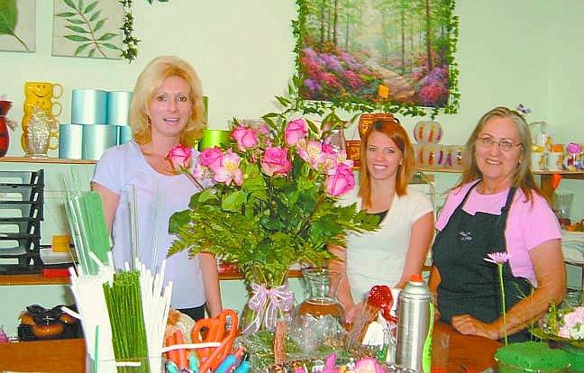 Mary Jean Kelso/Nevada Appeal News Service Lori Patrick, right, works on an arrangement at her shop, Always Flowers &amp; Fine Things, while employees Julie Fuller and Linda Freeland look on. A third employee, Jessica Eaton, is not shown.