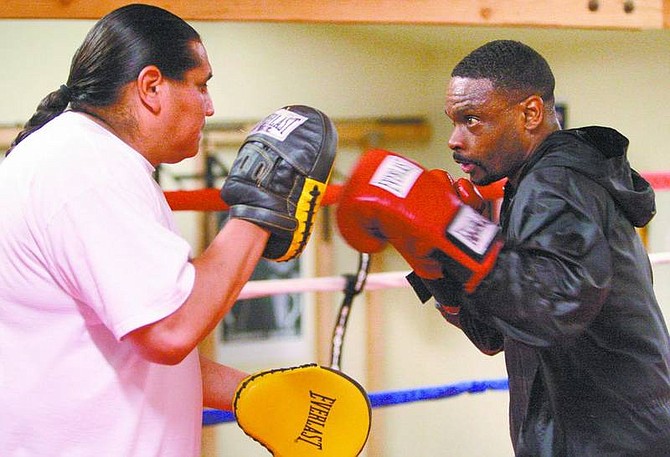 Cathleen Allison/Nevada Appeal Trainer Quentin Blue Horse holds the mitts for Jonathan Reid. Below: Middleweight Reid, of Nashville, Tenn., relaxes during a recent sparring session at Bruno&#039;s Boxing Gym in Carson City.