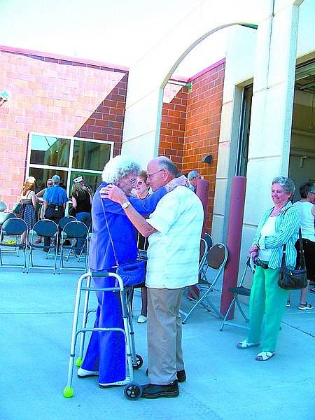 Karen Woodmansee/Nevada Appeal Longtime friend Reid Ross, who ran the sheriff&#039;s communication center when Les Groth was fire chief, comforts his widow, Margie Groth.
