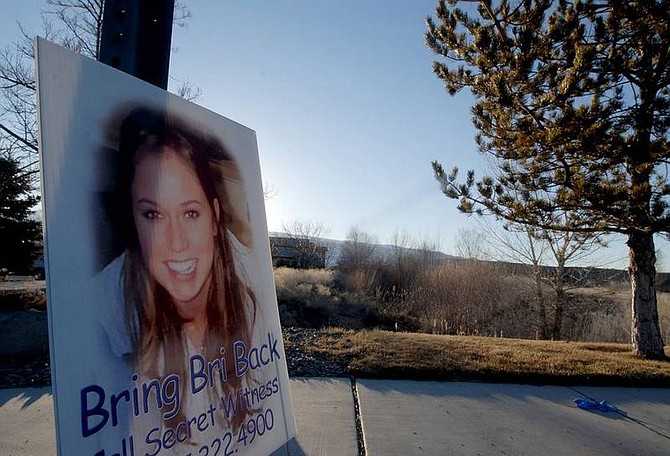 Kevin Clifford/Associated PressA sign with a photograph showing Brianna Denison, a 19-year-old college student missing since she was abducted nearly a month ago, is seen on Friday near a field where her body was found in Reno.