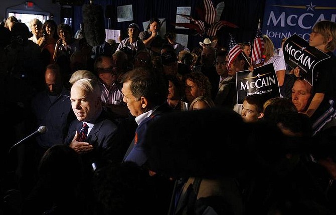 AP Photo/Charles DharapakResidents and supporters gather around as Republican presidential hopeful Sen. John McCain, R-Ariz., left, takes questions from reporters after a campaign event at the Shell Factory and Nature Park in North Fort Myers, Fla., Saturday, Jan. 26, 2008.