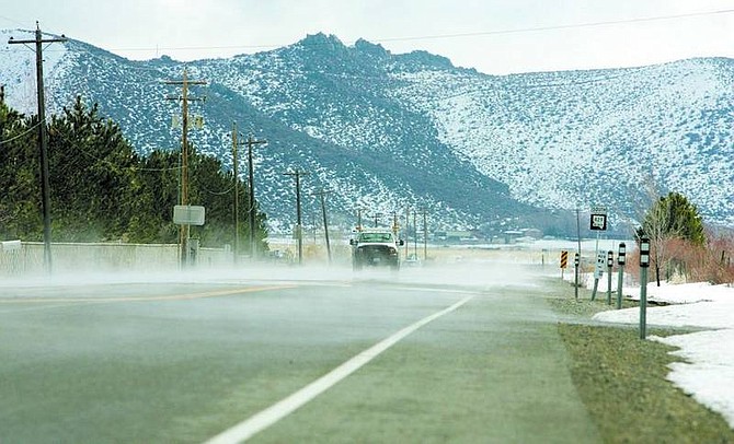 BRAD HORN/Nevada AppealTraffic travels on Old Highway 395 in Washoe Valley while steam rises from the road as temperatures rise on Wednesday afternoon.