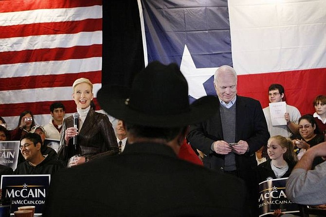 AP Photo/Gerald HerbertRepublican presidential hopeful, Sen. John McCain, R-Ariz., and his wife Cindy, take part in a campaign stop at the Mi Tierra Restaurant in San Antonio, Texas, on Tuesday.