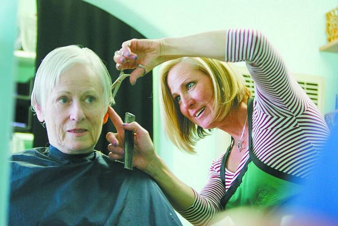 BRAD HORN/Nevada Appeal Linda Rich, owner of Hair It Is, cuts Linda Hatfield&#039;s hair at her Carson City salon on Thursday.