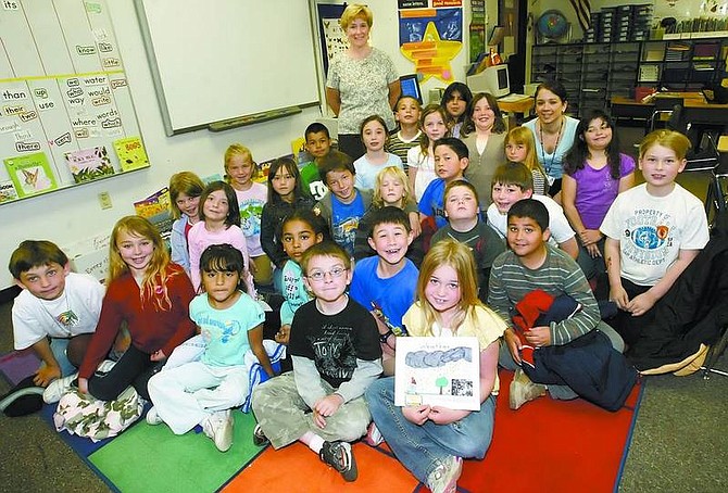 Amy Lisenbe/Nevada Appeal Fremont Elementary School second graders from Susie Owens&#039;, standing, and Becca Fleming&#039;s, back right, class with the book they authored and illustrated together titled &quot;Weather.&quot;