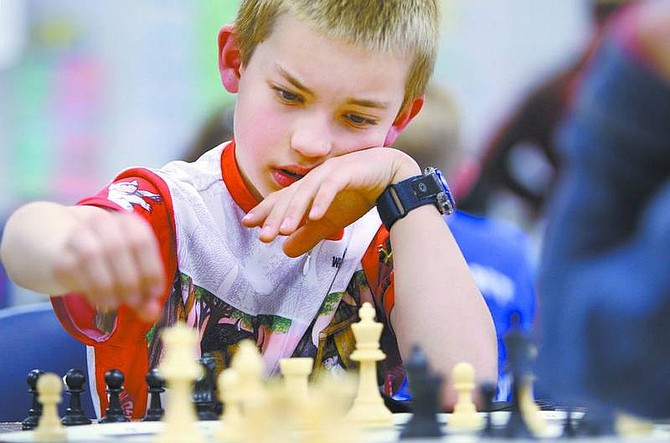 Cathleen Allison/Nevada Appeal Fremont Elementary School fourth-grader Fritz Steinle, plays chess against Tejashri Chavan (not in view), a Mark Twain fifth-grader during Tuesday&#039;s chess match.
