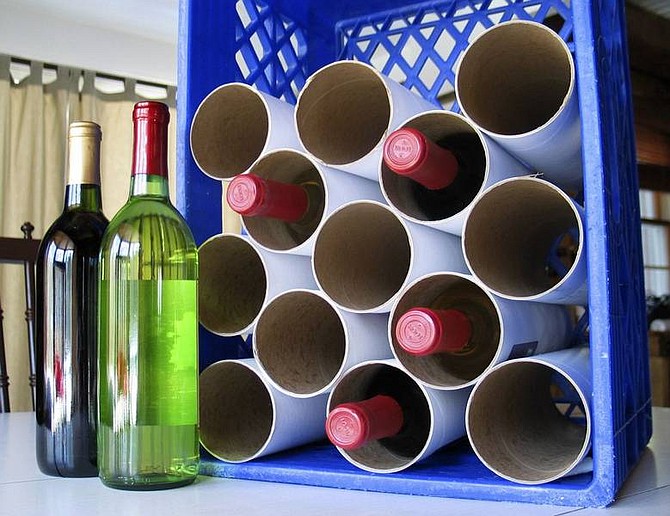 Photos by Stace Maude/Associated Press A wine rack made out of an old milk carton crate and mailing tubes is seen. Many household items can have second lives with a little thought.