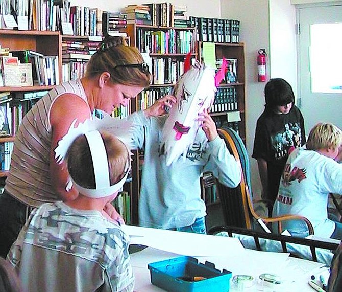 Photo provided The Silver City Volunteer Library hosts many youth events, including this African mask-making class with Arizona sculptor Richard Johnson. Pictured here is volunteer Teresa Panziera with Connor Panziera, 7, Nick Drum, 11, (in mask), and, in the background, Zach Alves, 11, and Zach Drum, 14.
