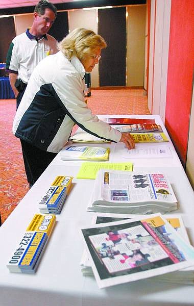 Amy Lisenbe/Nevada Appeal Joan Reid, a local attorney, looks over information for businesses about the Secret Witness program after the Carson City Chamber of Commerce luncheon Monday at the Nugget.