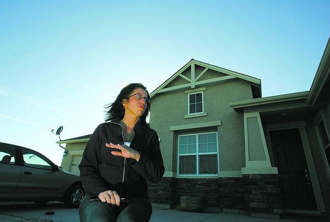 Bobbi Hammerstaedt, outside her home in the Waterford subdivision Thursday, discusses how subcontractors have placed a lien on her house because they haven&#039;t been paid by Landmark Homes and Development Inc.  BRAD HORN/Nevada Appeal