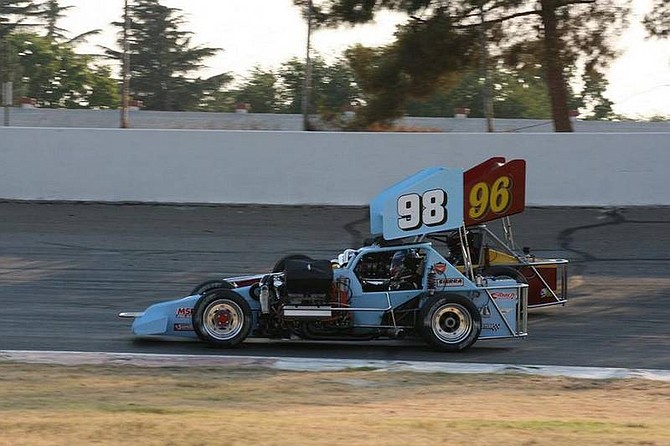 Rhonda Costa-Landers/Nevada AppealTroy Regier (98) makes an inside pass on Kenny White (96) for the lead and win in the first heat race of the Supermodifed Racing Association at Madera Speedway in Madera, Calif. Saturday.