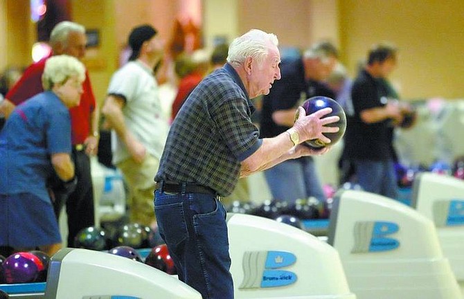 Photos by Amy Lisenbe/Nevada Appeal Coy Wiles, 90, of Klamath Falls, Ore., takes a turn in the ninth frame during a game Sunday afternoon at the 30th annual SP Mixed Fours Tournament at the Gold Dust West Bowling Center. Top, Linda Shipley, a member of the Gold Dust West Ladies team in Carson City, bowls during a practice session Sunday afternoon at the 2008 SP Mixed Fours Tournament at the Gold Dust West Bowling Center.