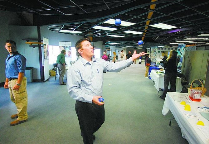 BRAD HORN/Nevada Appeal Jessie LaFollette of SOS Staffing juggles during the job fair at the Nevada Appeal on Saturday. Nearly a dozen employers, including the Appeal&#039;s parent company, Swift Communications Inc., were present during the event.