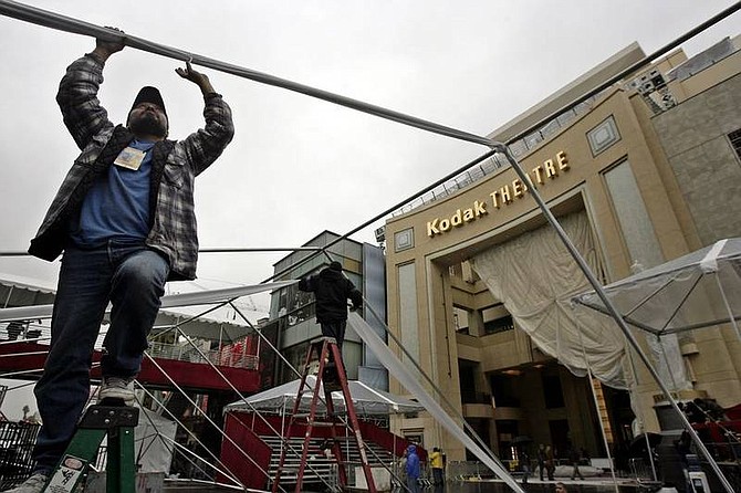 AP Photo/Ric FrancisRuben Roman, left, sets up a tent outside the Kodak Theatre in preparation for the 80th Annual Academy Awards in the Hollywood section of Los Angeles. The show will be presented Sunday.