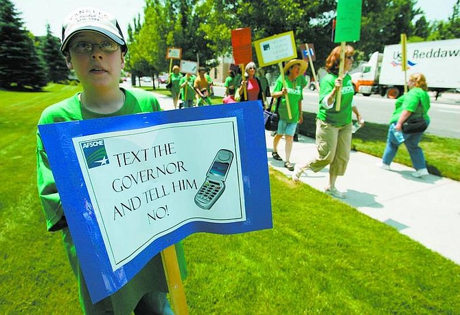 BRAD HORN/Nevada Appeal Austin Huff, 11, of Carson City protests in front of the Nevada State Legislature Building in Carson City, Nev., on Friday afternoon.