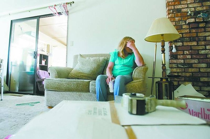 BRAD HORN/Nevada Appeal Kathy Brisby takes a break from packing at their east Carson City home on Friday afternoon. Lena Brisby, Kathy&#039;s mother, who has lived at the home for 20 years, has to be out by the end of the month.